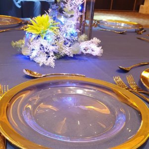 Table setting with gold rim glass charger plate