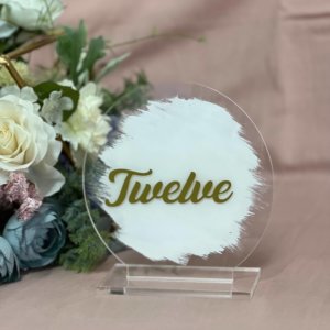 Round acrylic gold table number painted with white background