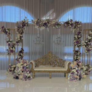 gold lattice arch with lilac artificial flowers